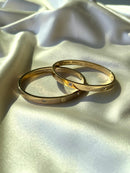 Two gold bracelets with engraved designs, handmade
