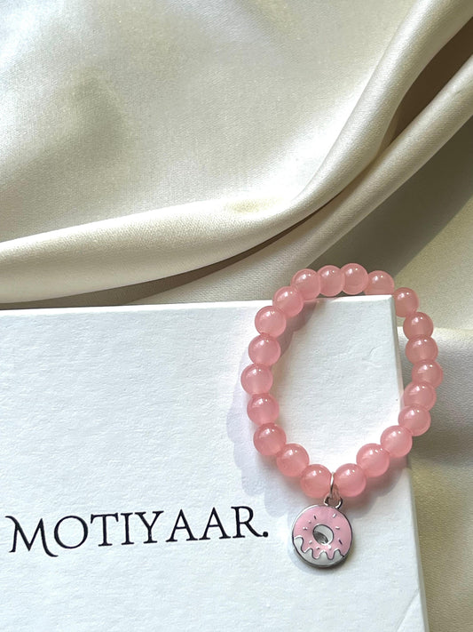 Pink beaded bracelet with a donut charm, handmade